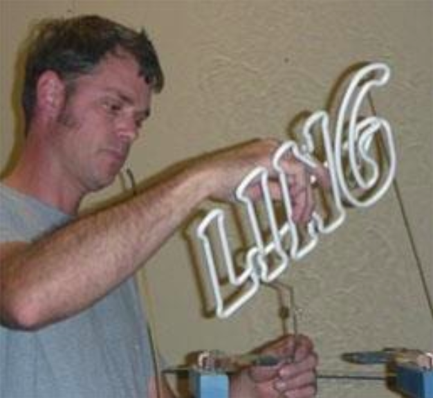 Image of Marlon working on a sign